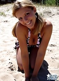 Beach teen squeezes her big boobies